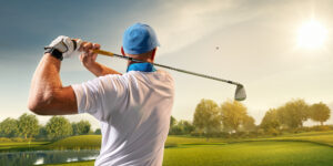Male Golfer Watches His Ball Sail Into the Distance After A Great Swing He Attributes to His PRP Therapy